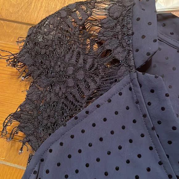 Subtle polka dots and lace cap sleeves make this navy blouse a must-have - Picture 3 of 4